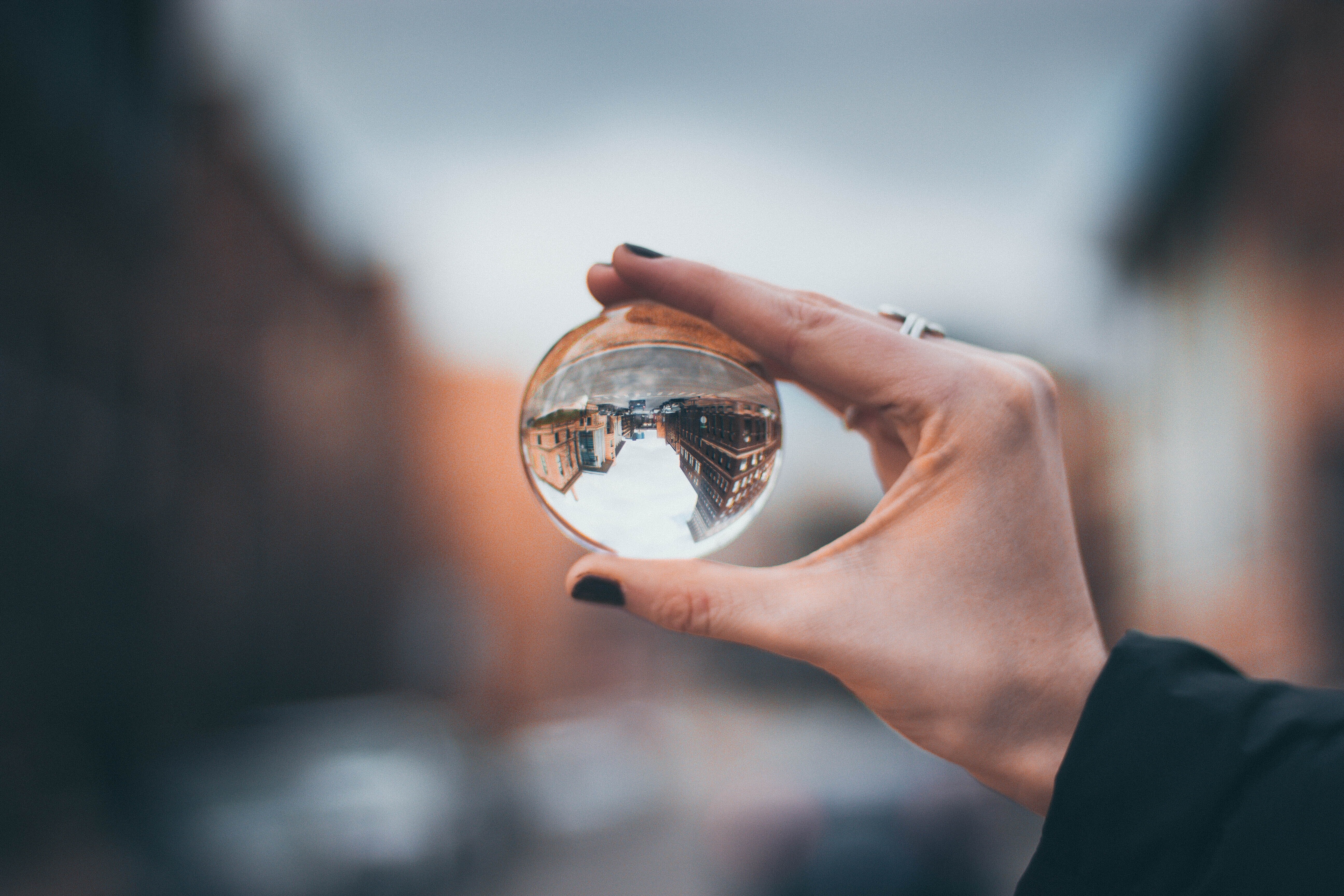 holding a glass orb