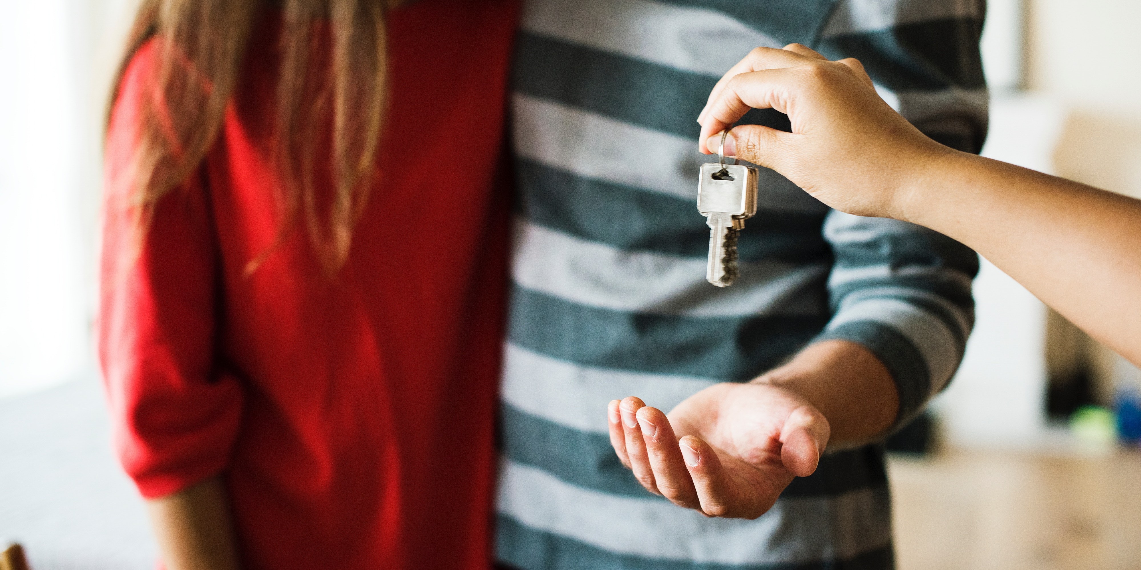 handing over keys to couple for affordable housing