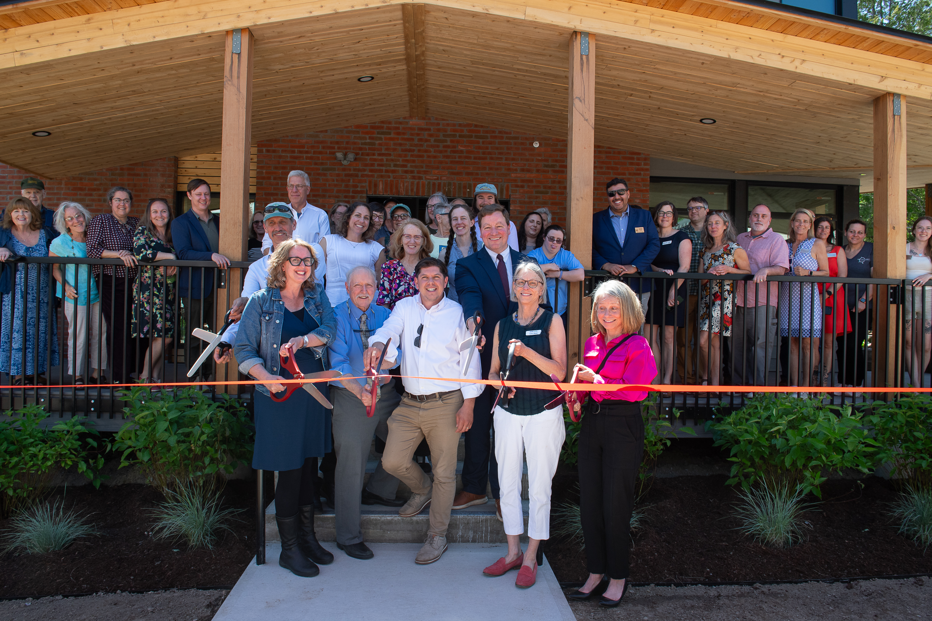 Image of folks cutting the ribbon at Marsh House in Waterbury