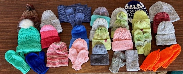 A photo of hats and mittens that folks have donated to the Speranza Inn